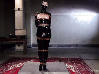 Dani Is Covered In Latex; Her Face Is Nearly Completely Encased Within The Latex Mask. One Of The Masters Uses A Torture Device On Her Nipples. The Po