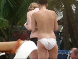 Our Candid Camera On The Beach Caught This Sexy Video Of A Topless College Girl Walking Around And Oiling Up Her Friend Before She Decided To Cover He